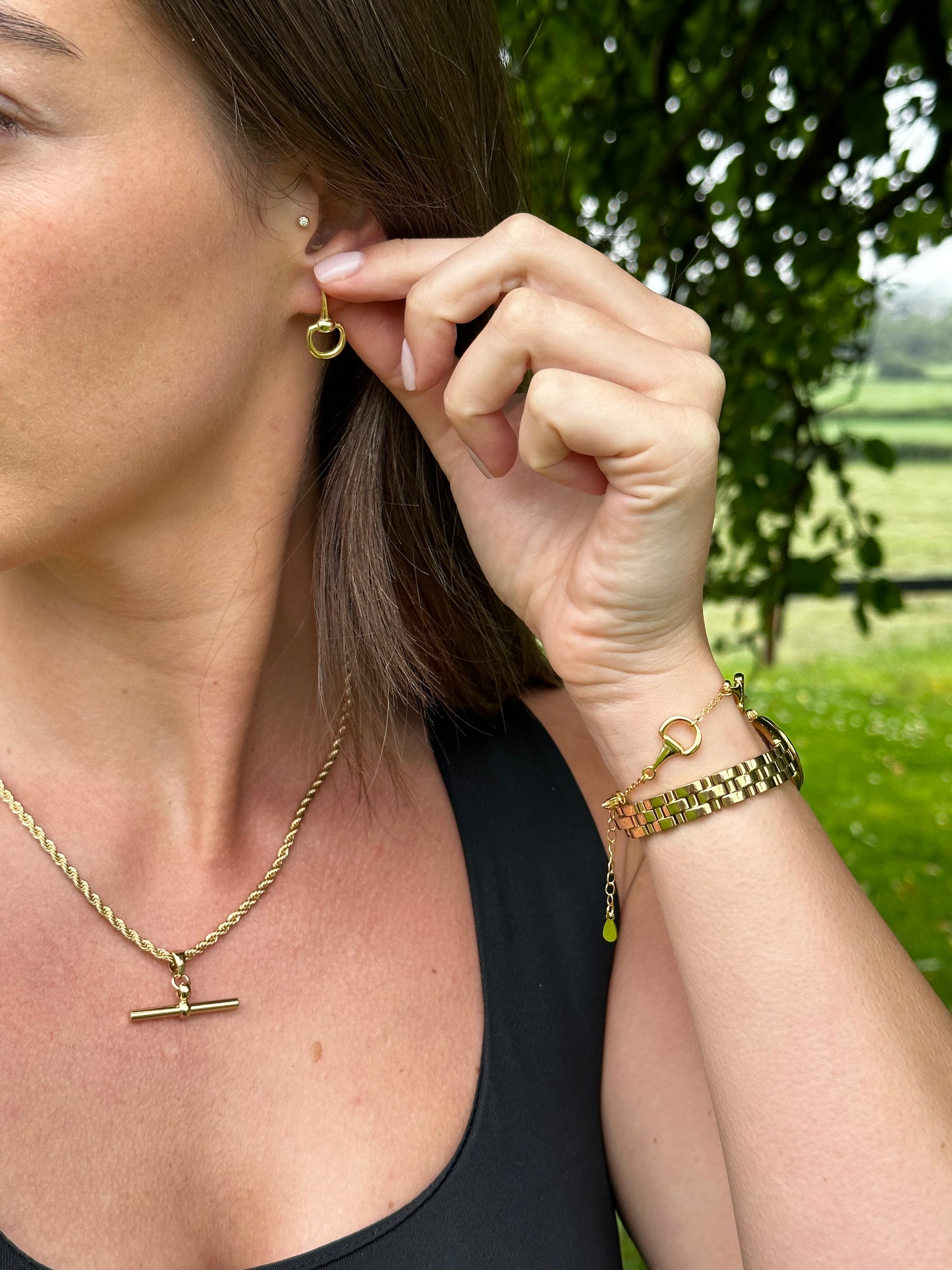 Half snaffle gold earrings